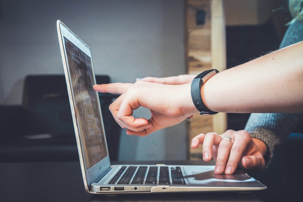 People collaborating with digital devices to plan audience-focused online communication